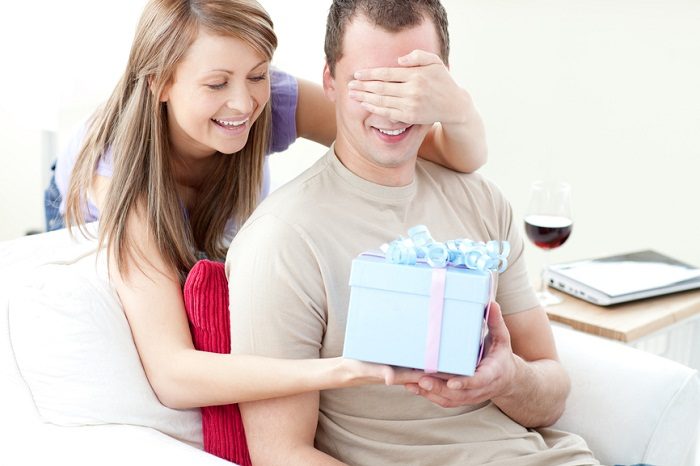 smiling-woman-giving-a-present-to-her-boyfriend